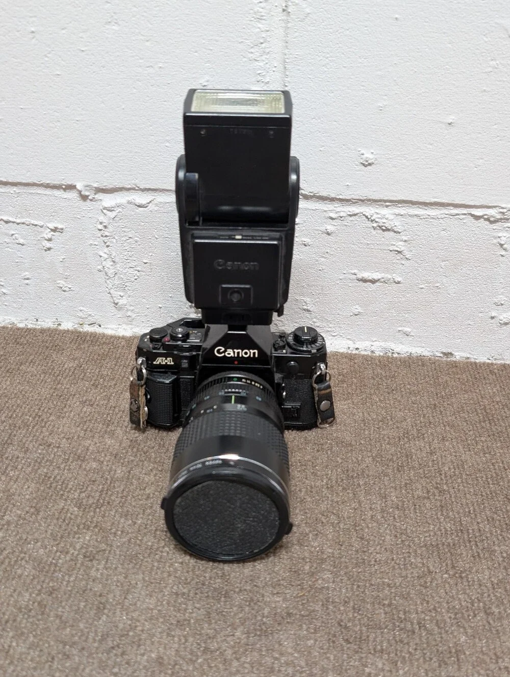 Vintage Canon A-1 Black SLR Camera with Black Lens and Black Flash